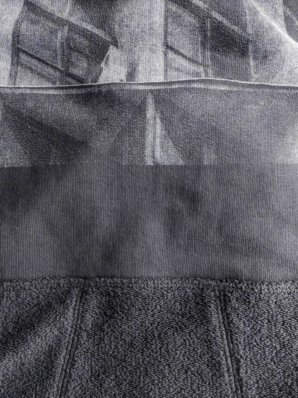 Close-up of a textured gray fabric with a high-quality screen print for long-lasting wear.