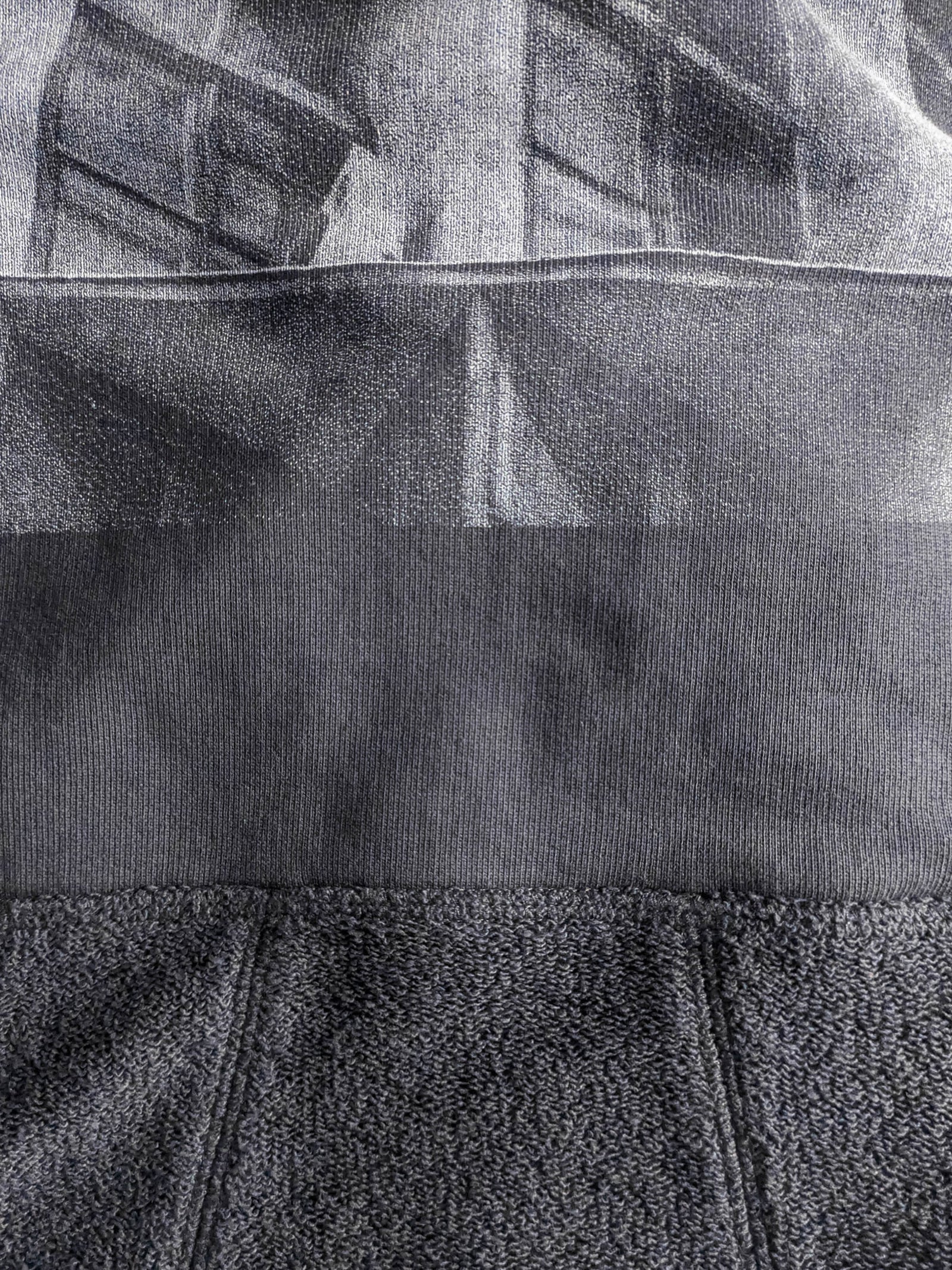 Close-up of a textured gray fabric with a high-quality screen print for long-lasting wear.